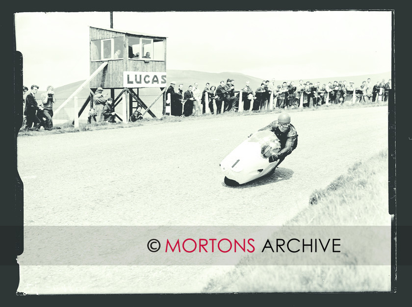 053 SFTP SENIOR TT 1957 06 
 A golden day at the Senior TT, 1957 - Jackie Wood (Norton) roaunds a corner as spectators look on 
 Keywords: 1957, Glass plate, Isle of Man, Mortons Archive, Mortons Media Group Ltd, Straight from the plate, The Classic MotorCycle, TT