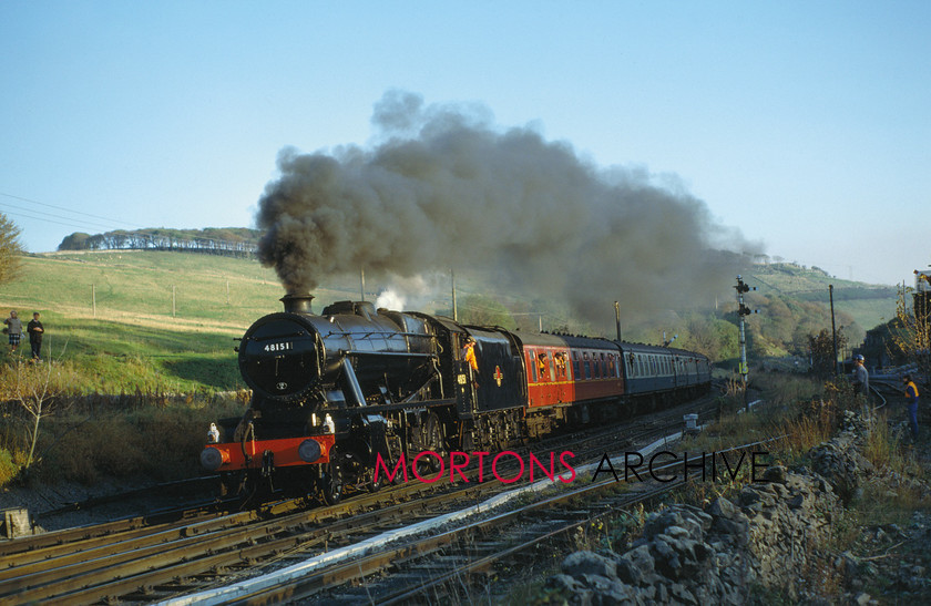 WD594820@64 preservation 00 
 Newly-restored and on its first working, substituting for Flying Scotsman, LMS 2-8-0 No 48151 passes Great Roacks Junction, returning from Buxton on 24th October 1987. 
 Keywords: Heritage Railway, Mortons Archive, Mortons Media Group