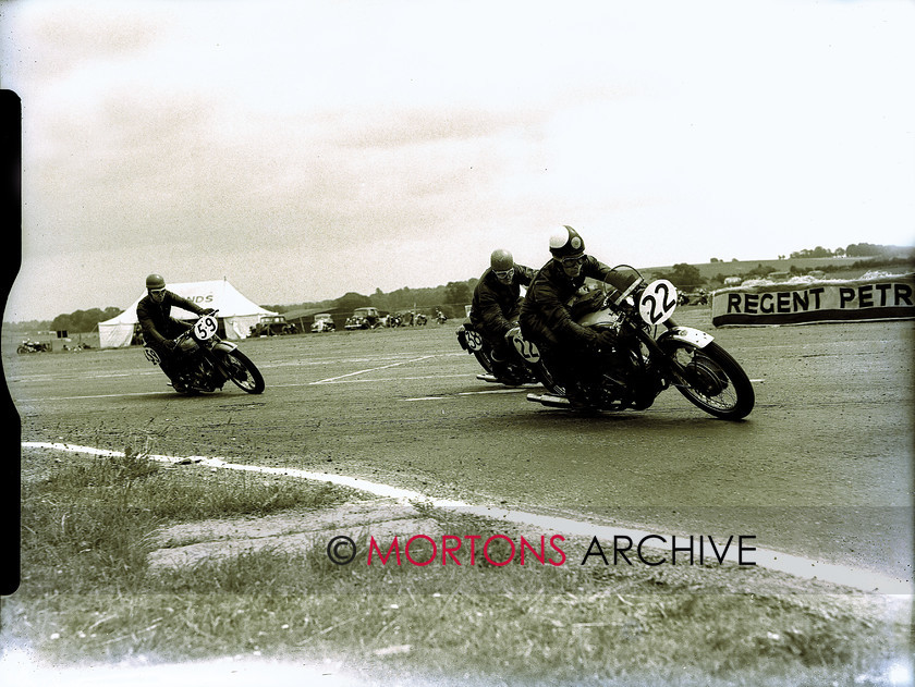 plate 17281-14 
 The fancied Geoff Tanner/Geoff Monty Goldie leads the similarly mounted Keen/Jackson and the Hughes/Stevens Tiger ton-ten Triumph. Atlas, the Geoffs retired. 
 Keywords: 1956, July 2011, Mortons Archive, Mortons Media Group, Straight from the plate, The Classic MotorCycle, Thruxton